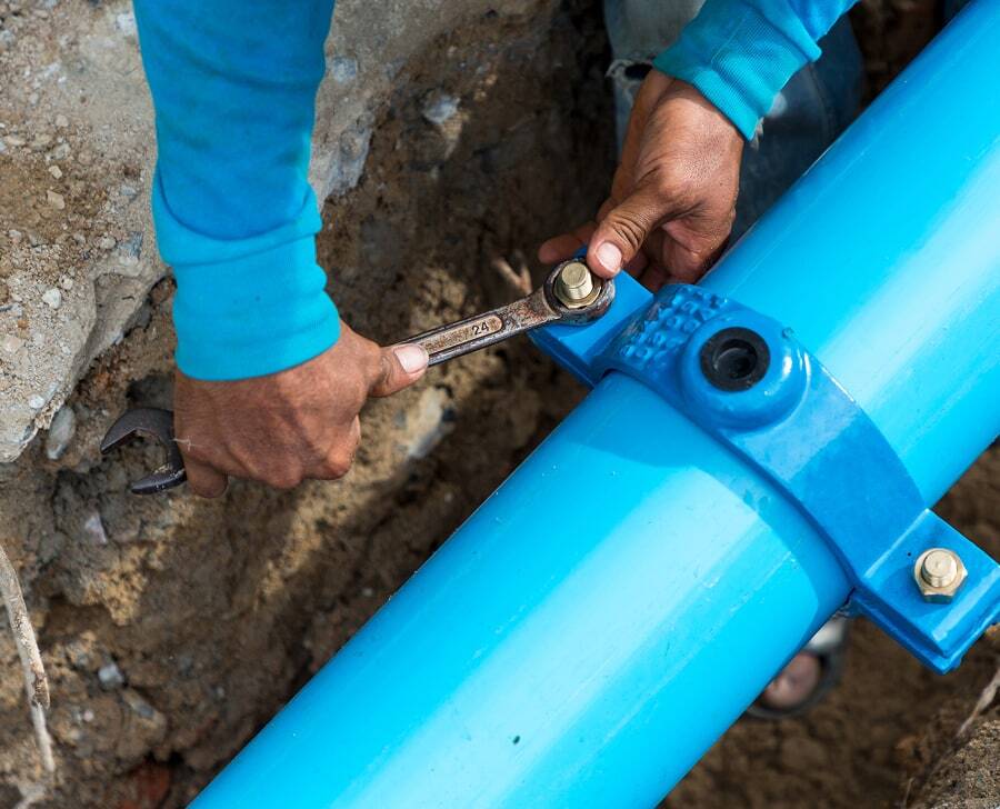 maintenance technician securing a large pipe