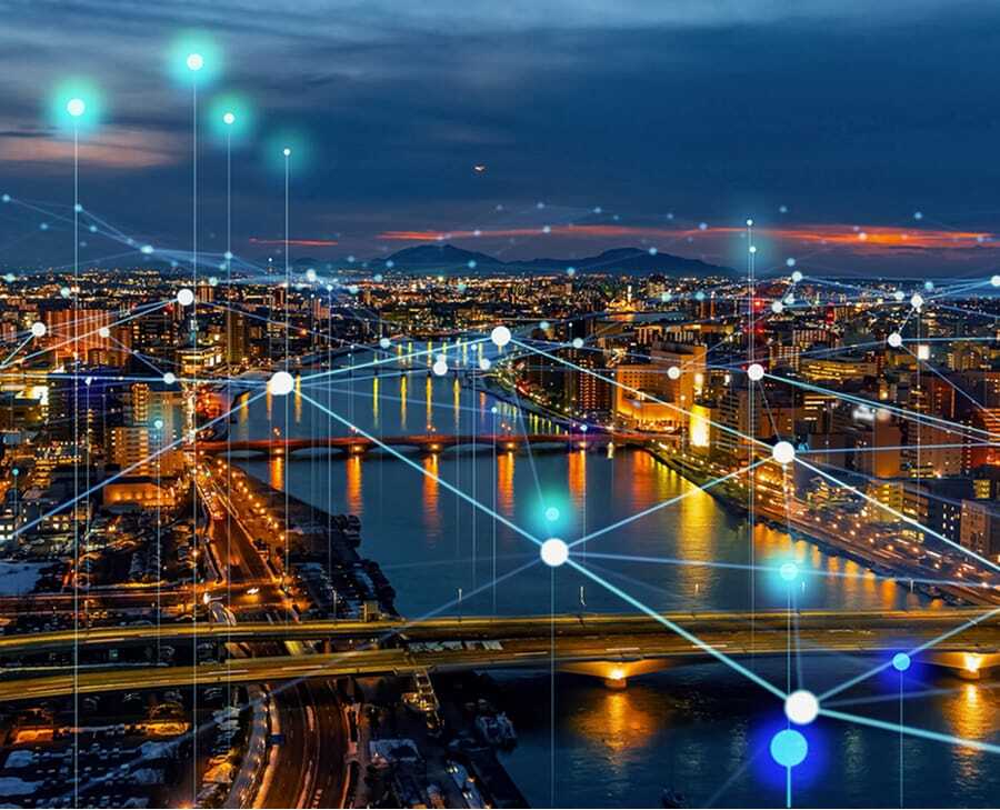 aerial timelapse photo of city with illuminated grid overlay suggesting infrastructure connectedness