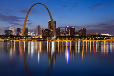 St. Louis skyline at dusk with the Gateway Arch reflected in the Mississippi River, symbolizing the city’s innovation and infrastructure leadership.